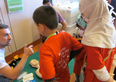 Girl with headscarf and boy at Vienna Children's University Wokshop on First Aid