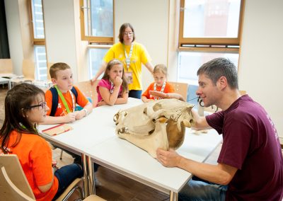 a Lecturer presents a giant animal skull bone