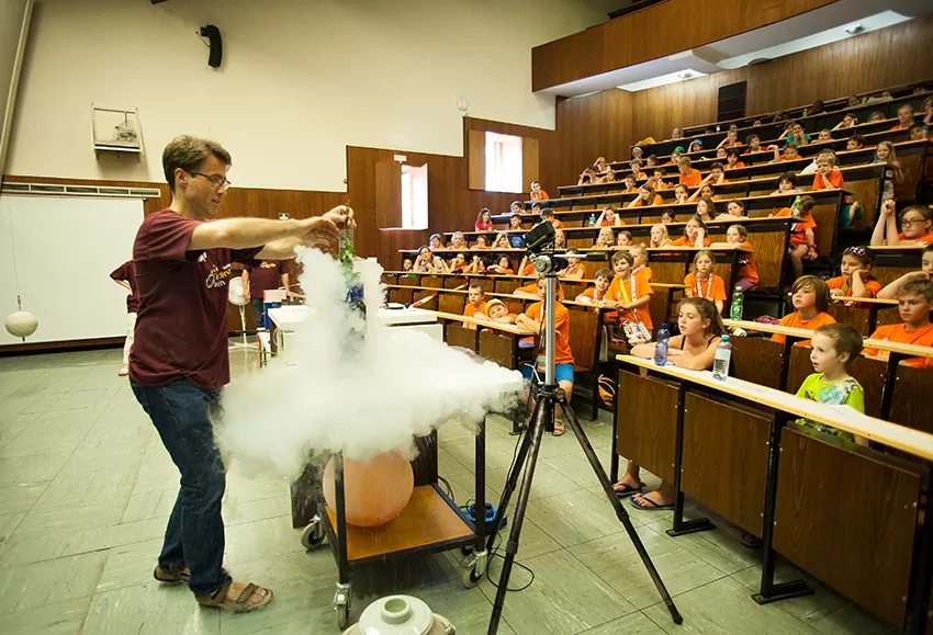 ein Lehrender experimentiert mit flüssigem Stickstoff im Hörsaal